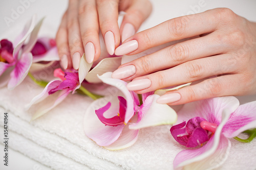 Woman demonstrates a fresh manicure made by a beauty studio