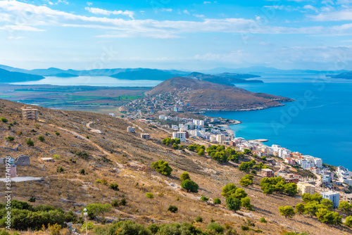 Ragged coastline of Sarande viewed behind a lighthouse, Albania photo