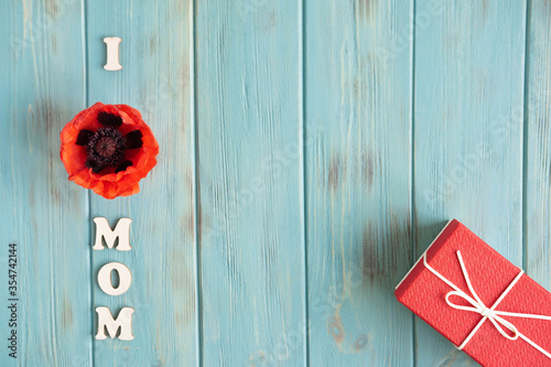 I love mom. Conceptual mother's day and birthday background with gift box. Flat lay, top view.