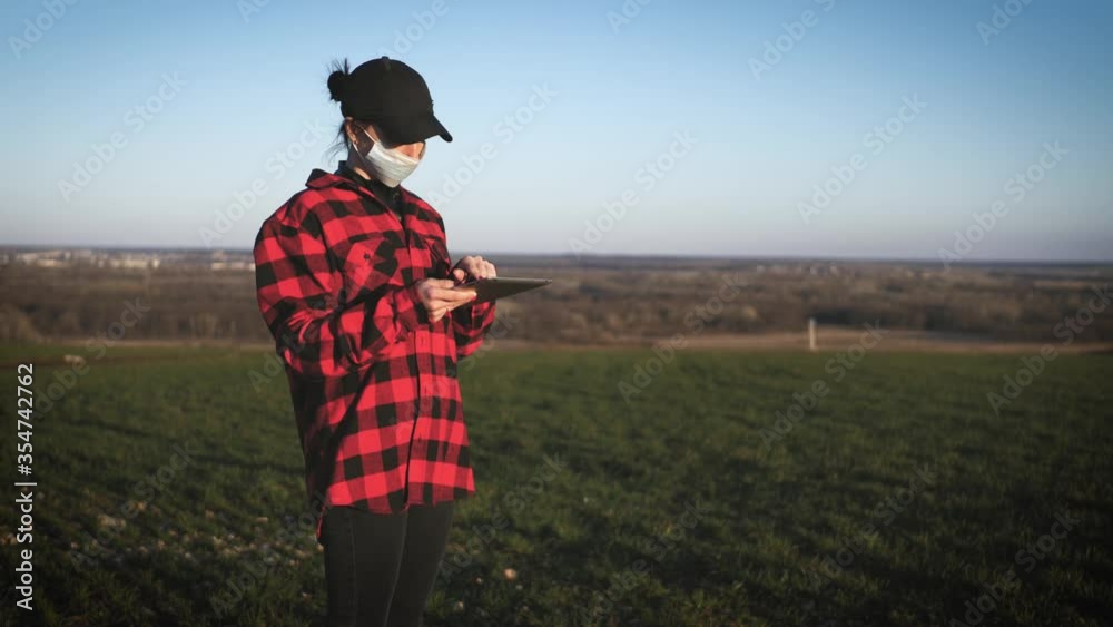 Agronomist using a digital tablet in an agriculture field. Agronomist using a digital tablet in an agriculture field.
