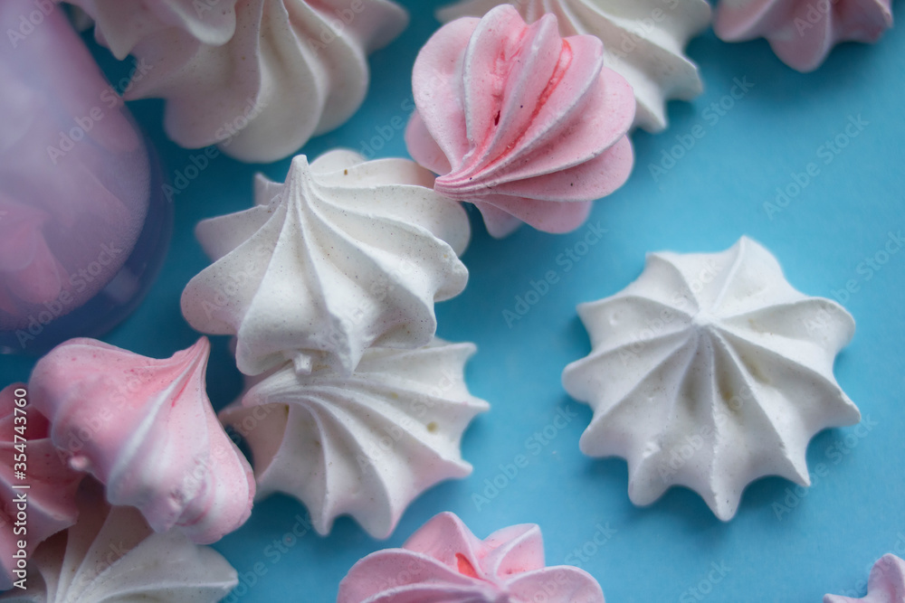 Sweet delicate meringues on a blue background
Sweet delicate meringues on a blue background