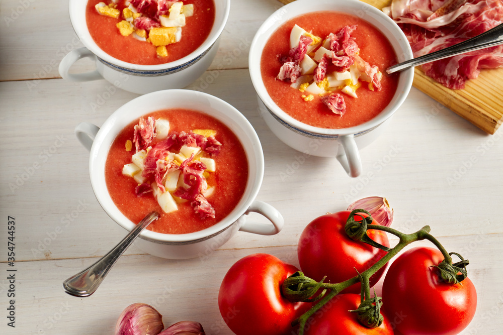 Tomato soup, salmorejo, with raw ingredients on a table Tomato soup, salmorejo, with raw ingredients on a table