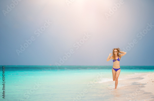 Woman laying on the beach enjoying summer holidays © travnikovstudio