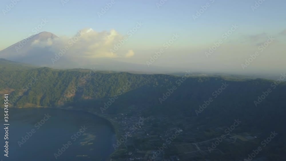 Scenic view of hills and mountains with clouds sky and lake on summer day. Beautiful mountain slopes covered with white clouds, blue sky and lake. outdoor, nature landscape. Scenic view of hills and mountains with clouds sky and lake on summer day. Beautiful mountain slopes covered with white clouds, blue sky and lake. outdoor, nature landscape.