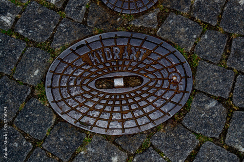 Old manhole in the city with the inscription "Hydrant"