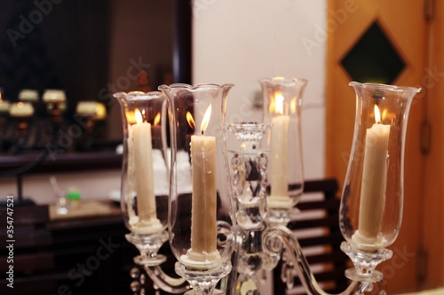 Four candle flames in antique glass