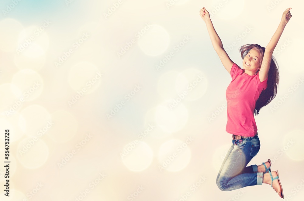 Cheerful young woman jumping on pastel background Cheerful young woman jumping on pastel background