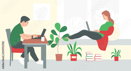 A couple of freelancers work from home. A guy and a girl with laptops. 