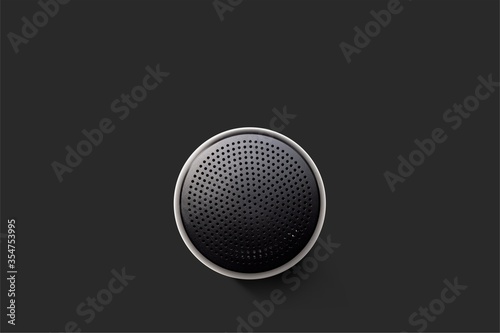 Black Wireless Bluetooth Speaker Isolated on Plain Black Background, Viewed From Above; Top View of Music Player Showing Perforated Metal Grille Holes.