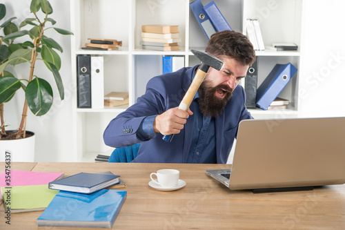 Hateful job. Bad computer. Annoying ads and pop up banners. Slow internet connection. Outdated software. Computer lag. Lagging system. Hate office routine. Man bearded crush computer. Destroy laptop