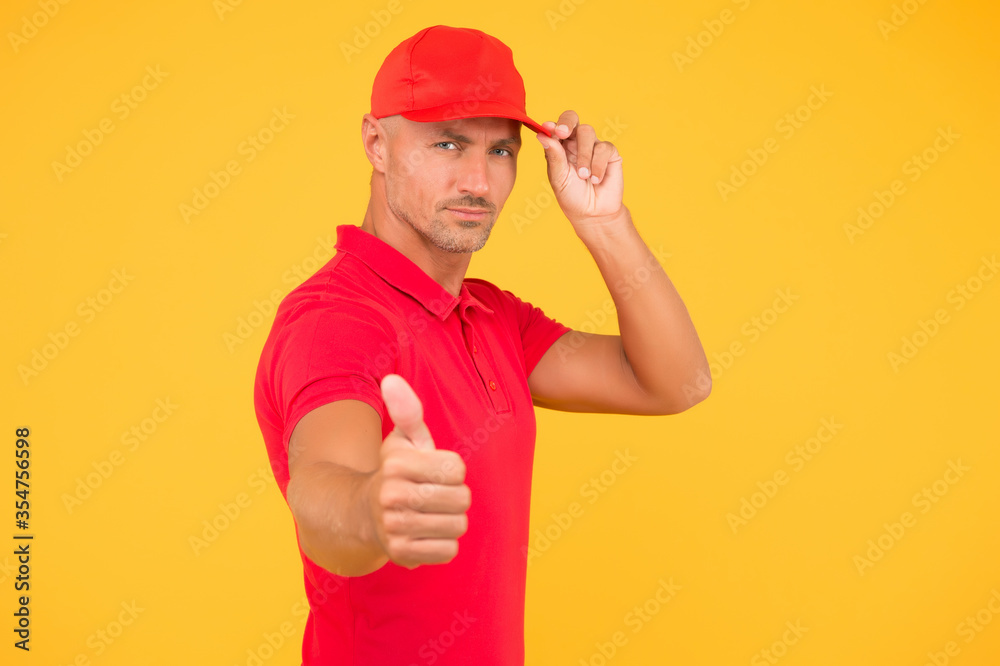 Try the best product. Serious guy in cap give thumbs up yellow background. Approving and promoting. Promoting product or service. Sales promotion. Promoting and advertising. Promoting and marketing
