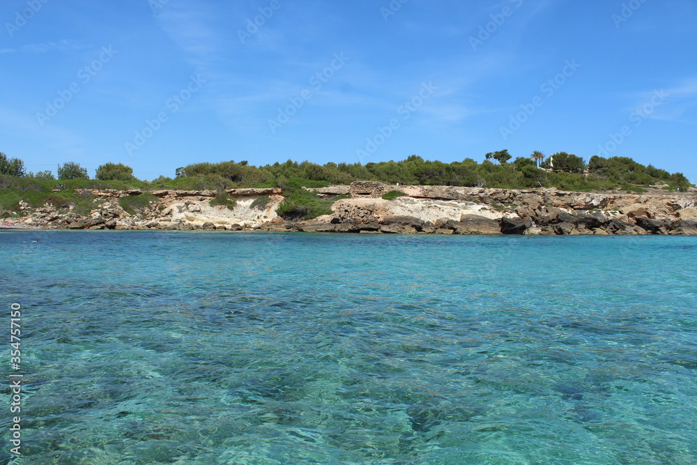 Turquoise waters off Sant Joan Beach - Platja de Sant Joan - Majorca, Spain