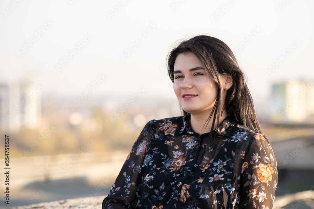 Portrait of a happy black haired woman on warm summer day outdoors. Portrait of a happy black haired woman on warm summer day outdoors.