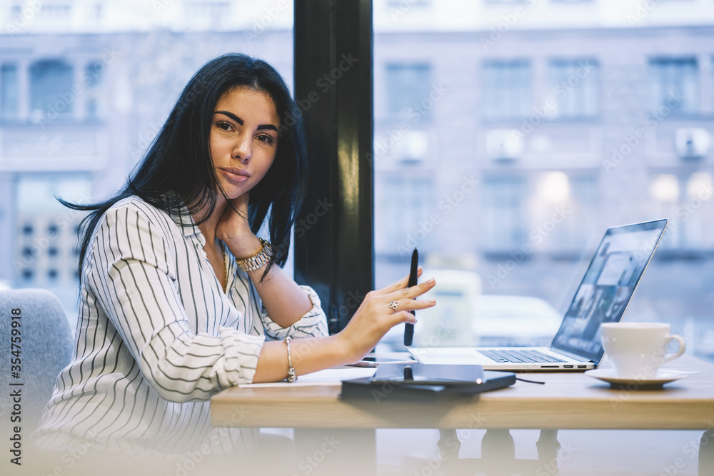 Modern business woman working in coffee shop interior online Modern business woman working in coffee shop interior online
