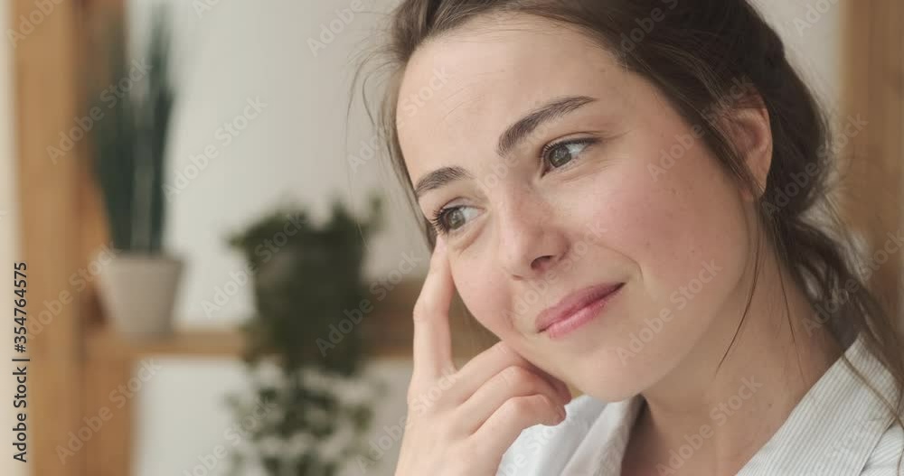 Satisfied woman thinking and planning at home