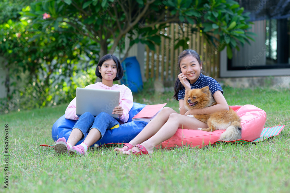 schoolgirl asia studying online lesson at home with teacher. Elementary school student Listen to teachers teach online at home.homeschooling schoolgirl asia studying online lesson at home with teacher. Elementary school student Listen to teachers teach online at home.homeschooling