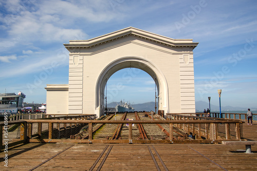 Photography White arch and warship at pier 41, San Francisco, California, USA
