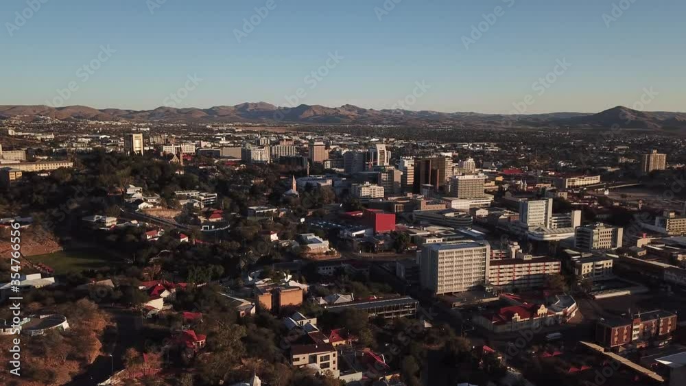 4K aerial afternoon video of savanna hills, Windhoek central business district, residential suburb, water tanks, mountains around city in central highland of Namibia, southern Africa 4K aerial afternoon video of savanna hills, Windhoek central business district, residential suburb, water tanks, mountains around city in central highland of Namibia, southern Africa