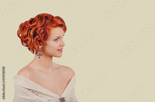 retro beauty girl curly up hairdo style posing in studio in side profile