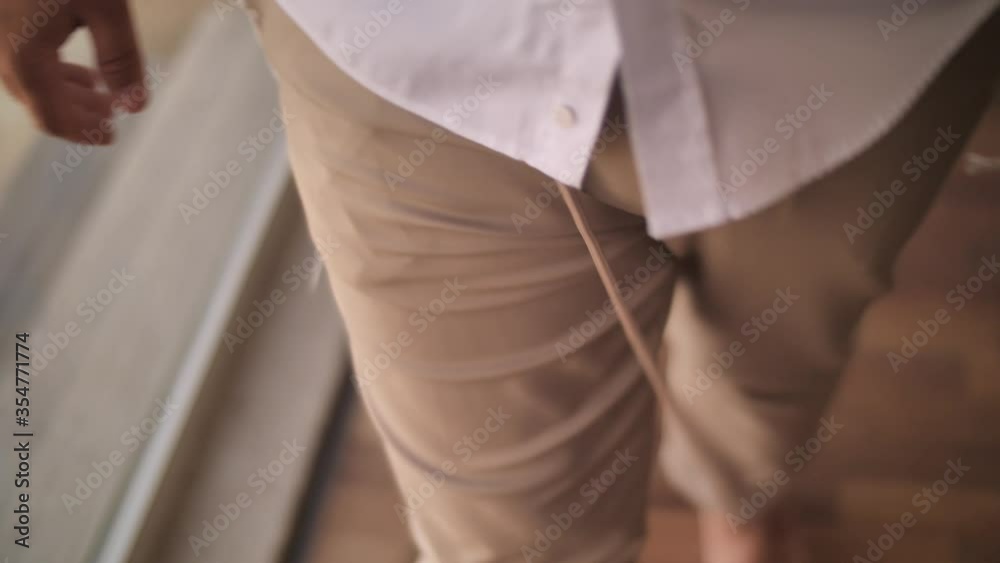 Close up on ritual knotted fringes, part of tallit put under shirt of Jewish Man Close up on ritual knotted fringes, part of tallit put under shirt of Jewish Man