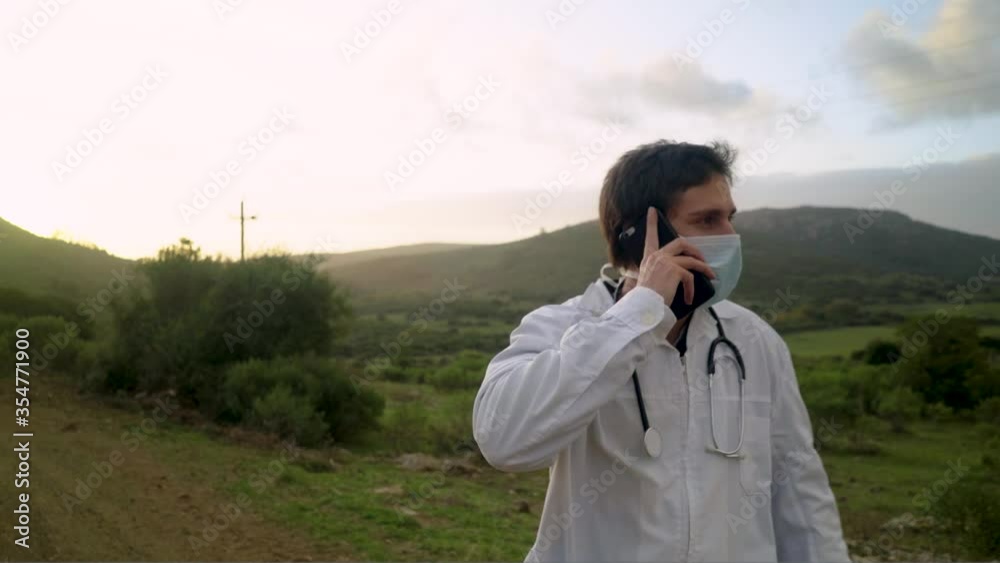 Doctor talking on the cell phone on rural dirt road Doctor talking on the cell phone on rural dirt road