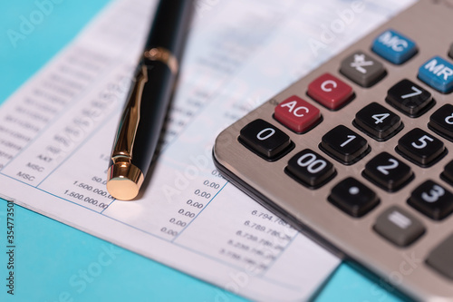 calculator and stationery items on the table for financial activity