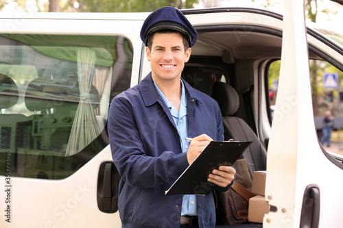 Handsome young postman near...