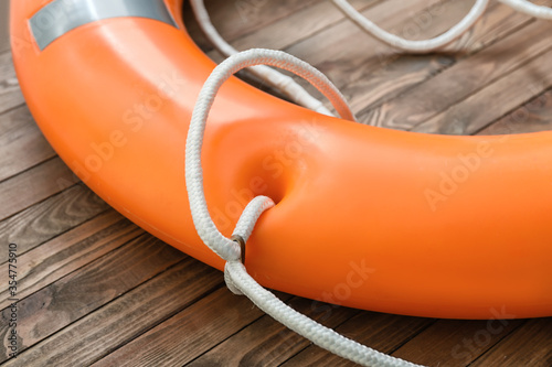 Lifebuoy ring on wooden background photo