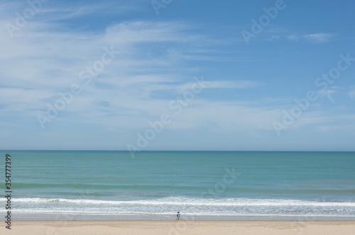 Amazing view of a sandy beach on a cloudy sky background photo