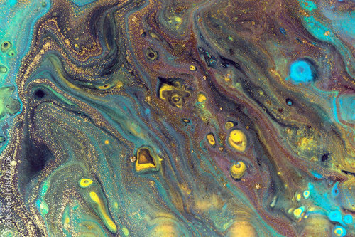 Dark liquid pattern with bright blue and gold cells.