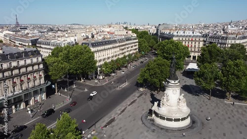 Flying over Republic square with Eiffel tower in background. Sky for copy space photo