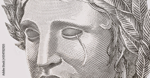detail of the Brazilian money bill, real, crying, tears streaming down her face. Concept of Brazilian social and financial crisis. photo