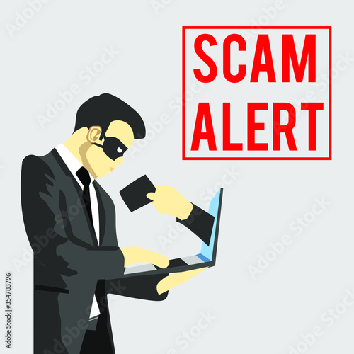 scammer holding a laptop