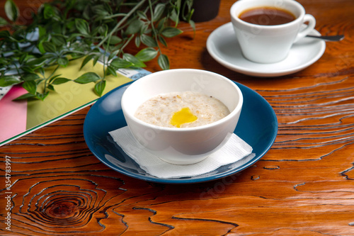 Oatmeal with butter and coffee for breakfast at home