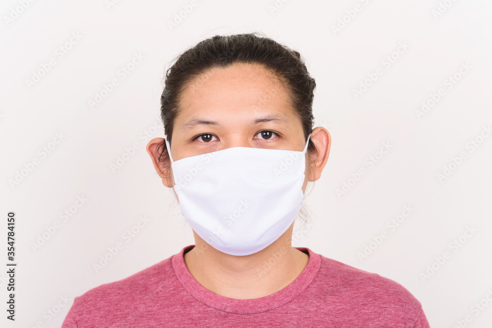 Portrait of Asian man wearing white fabric mask to protection corona virus outbreak and pollution Portrait of Asian man wearing white fabric mask to protection corona virus outbreak and pollution