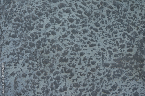 Gray concrete background with dark spots
