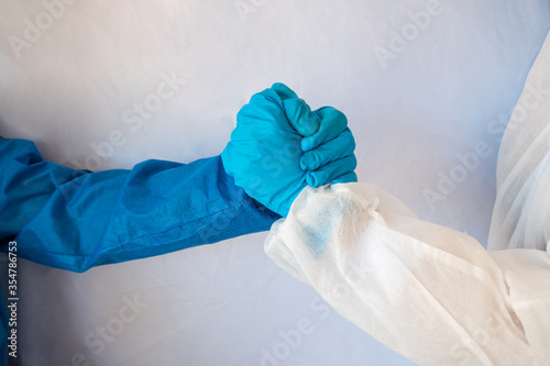 Hands of friends in medical gloves greeting each other isolated on white background.