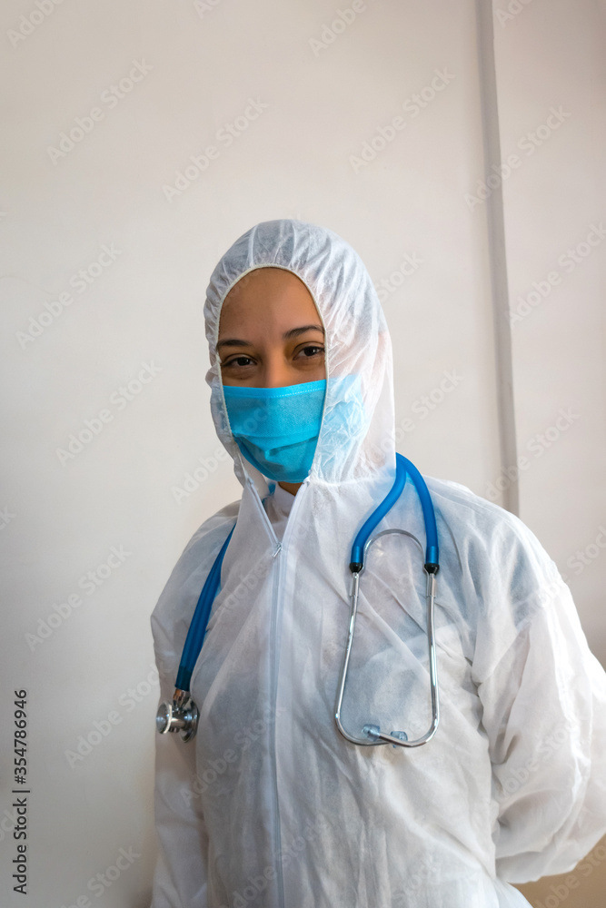 Portrait of a Latino doctor in a PPE protective suit with a mask. Portrait of a Latino doctor in a PPE protective suit with a mask.