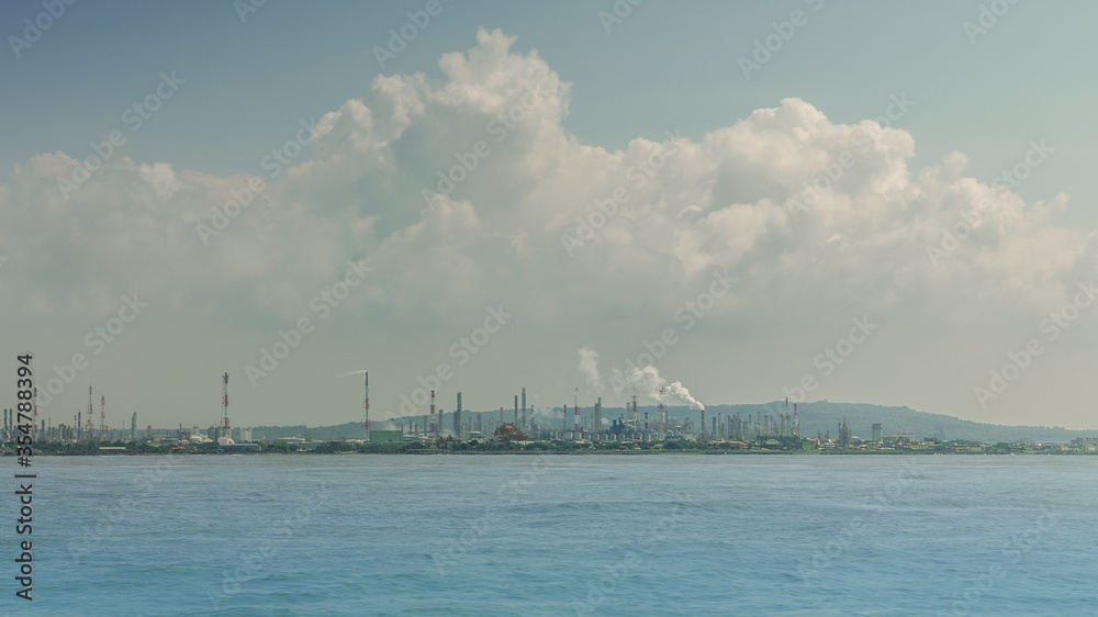 Industrial landscape view from the ocean. Sea pollution and ecological problem
