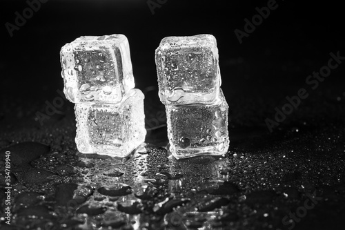 ice cubes on black table background. © peterkai