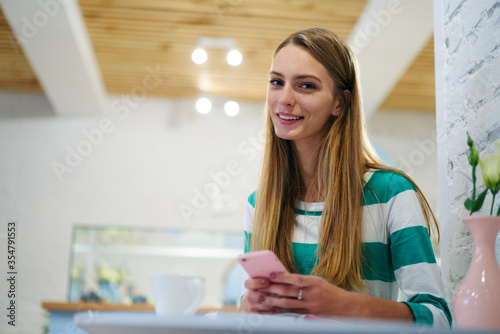 Young attractive female marketing manager banking via mobile phone 