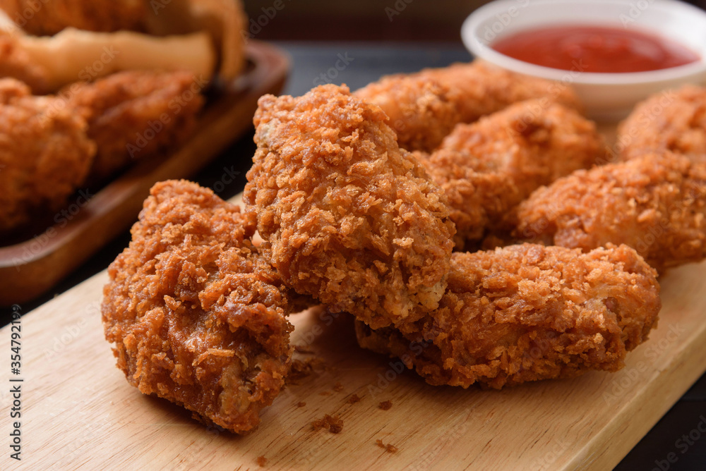 Fried breaded chicken wings on wooden table. Close up Fried breaded chicken wings on wooden table. Close up