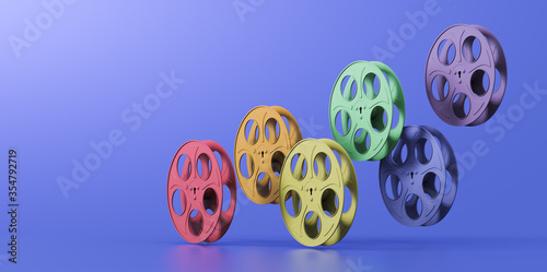 3D illustration of film reels arranged in a rainbow hue