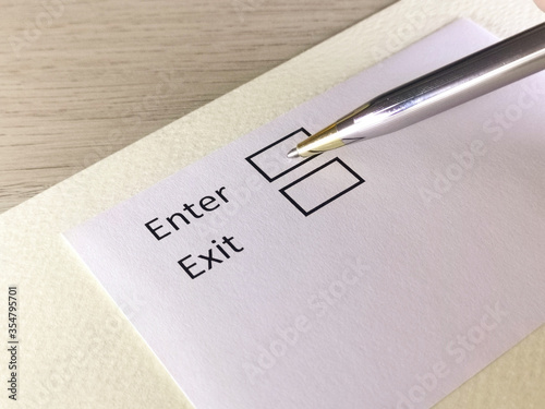 One person is answering question on a piece of paper. The person is thinking to enter or to exit.