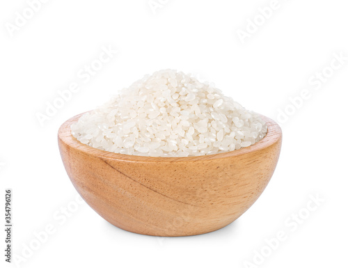 Rice in a wooden cup on a white background.