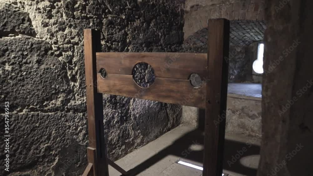 A terrifying wooden medieval torture equipment inside a real stone castle medium shot
