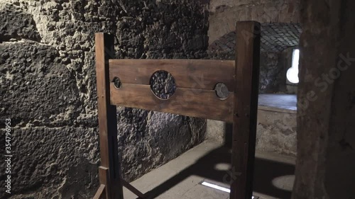 A terrifying wooden medieval torture equipment inside a real stone castle medium shot photo