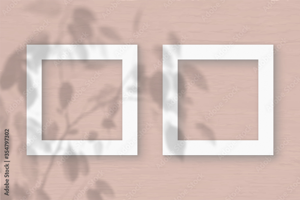 Fototapeta premium Two square sheet of white textured paper on the peach wall background. Mockup with an overlay of plant shadows. Natural light casts shadows from the leaves of an exotic plant. Flat lay, top view