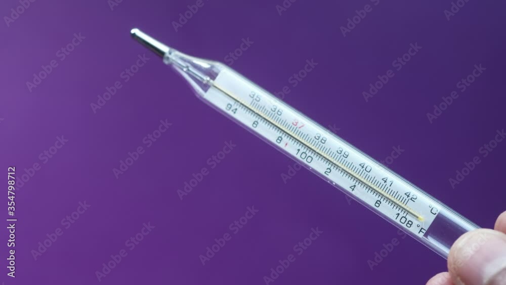 Man hand holding medical thermometer, close up. Man hand holding medical thermometer, close up.