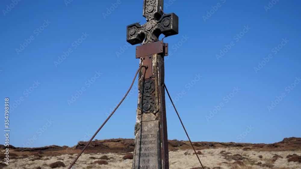 Old weathered 19th century Ashworth Cross memorial to James Platt MP dated 1857 on the top of the Dove Stone Moss hill overlooking Dovestone reservoir. Handheld camera tilt down. Old weathered 19th century Ashworth Cross memorial to James Platt MP dated 1857 on the top of the Dove Stone Moss hill overlooking Dovestone reservoir. Handheld camera tilt down.
